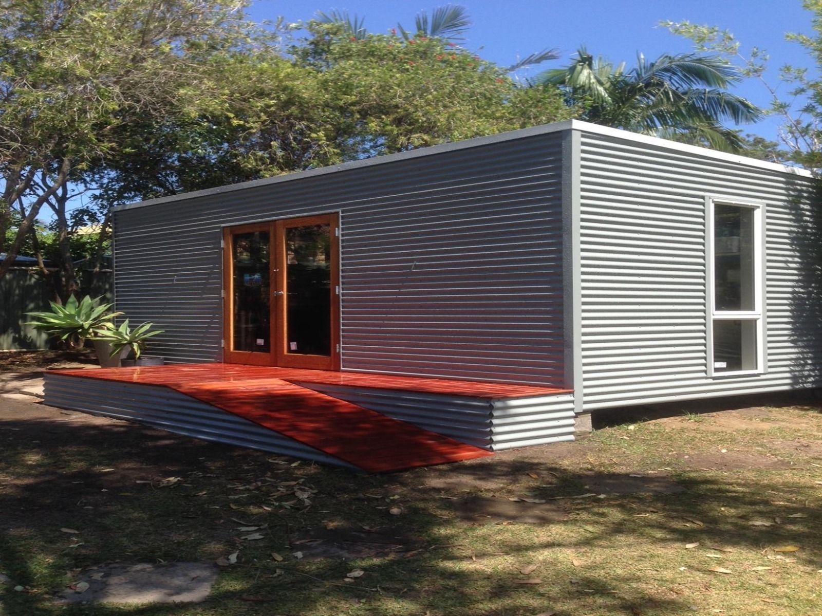 Example of completed backyard pod 6m x 3m (skillion roof) in Colorbond® Windspray® with added windows, doors, and deck. Example of completed backyard pod 6m x 3m (skillion roof) in Colorbond® Windspray® with added windows, doors, and deck.