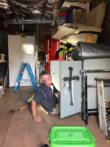 DIY Backyard Pod storage shed project - Mark busy installing a cabinet