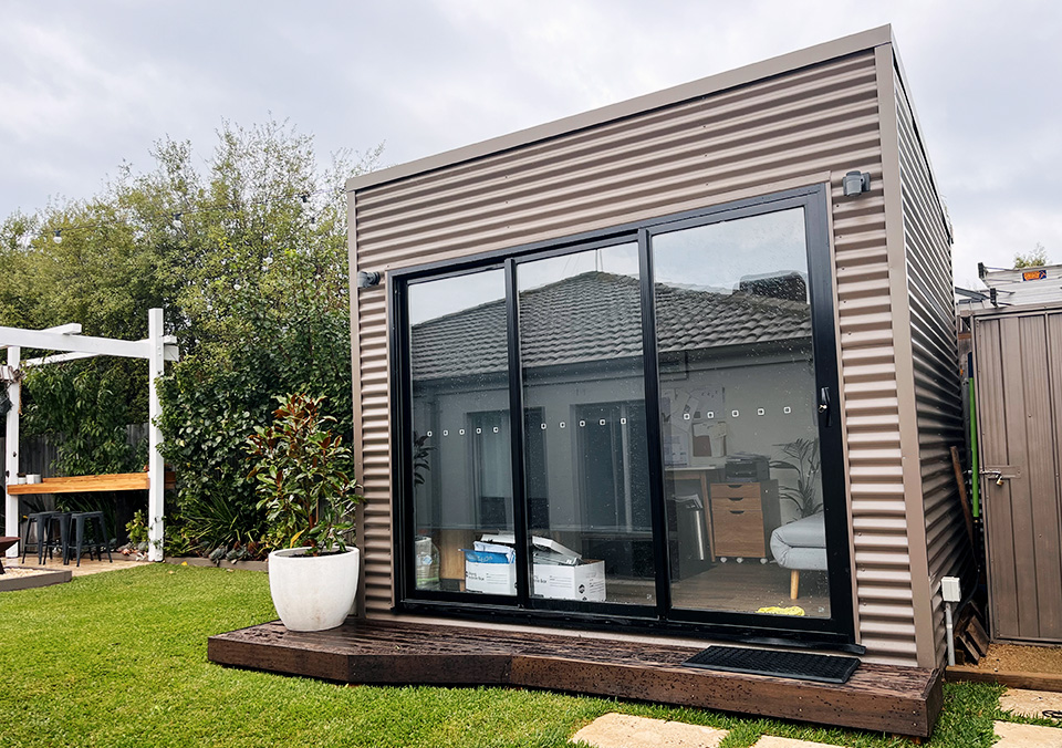 Our customer wanted a small home office pod against the boundary fence (usually a no-no) and it had to be an exact non-standard size to suit their design. They also wanted the low-cost structure to be attractive-looking to enhance the desirable coastal home with its existing focal-point backyard entertainment area. The finished home office pod, with its timber surrounds, proudly achieves its purpose inside and out.